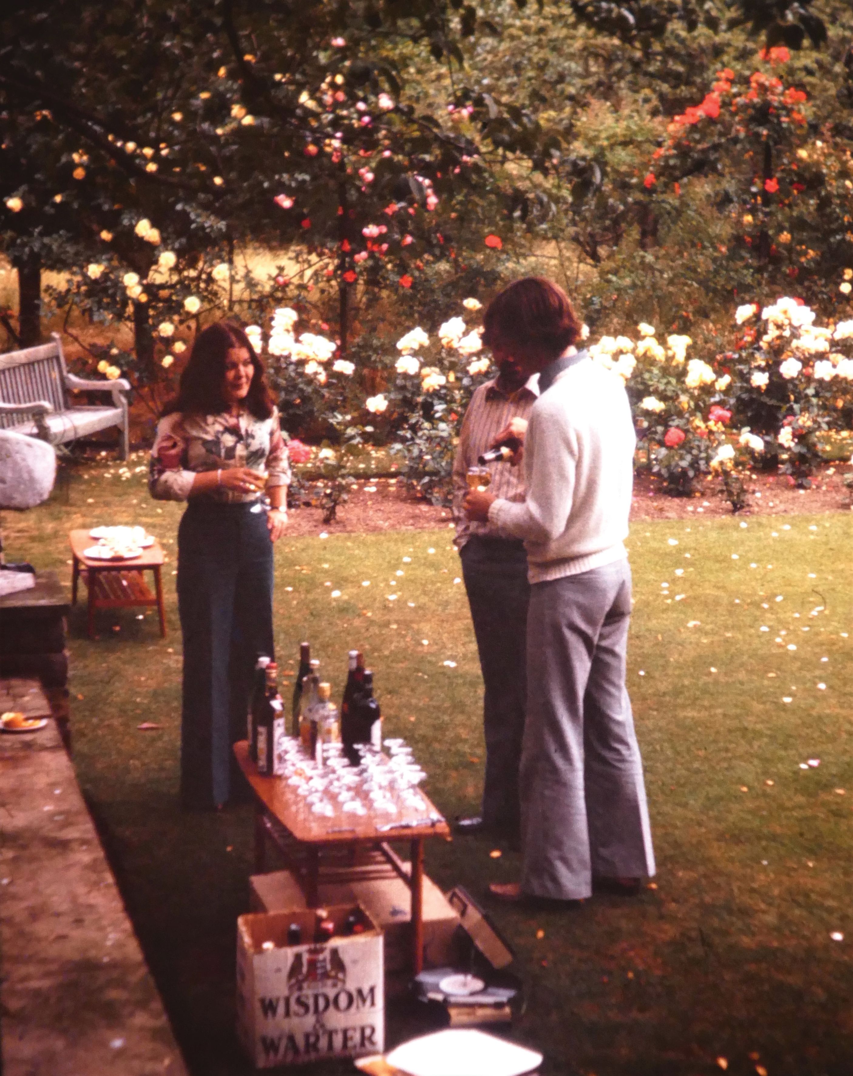 Hilary Carter and Nigel Long enjoy drinks in the Rose Garden.