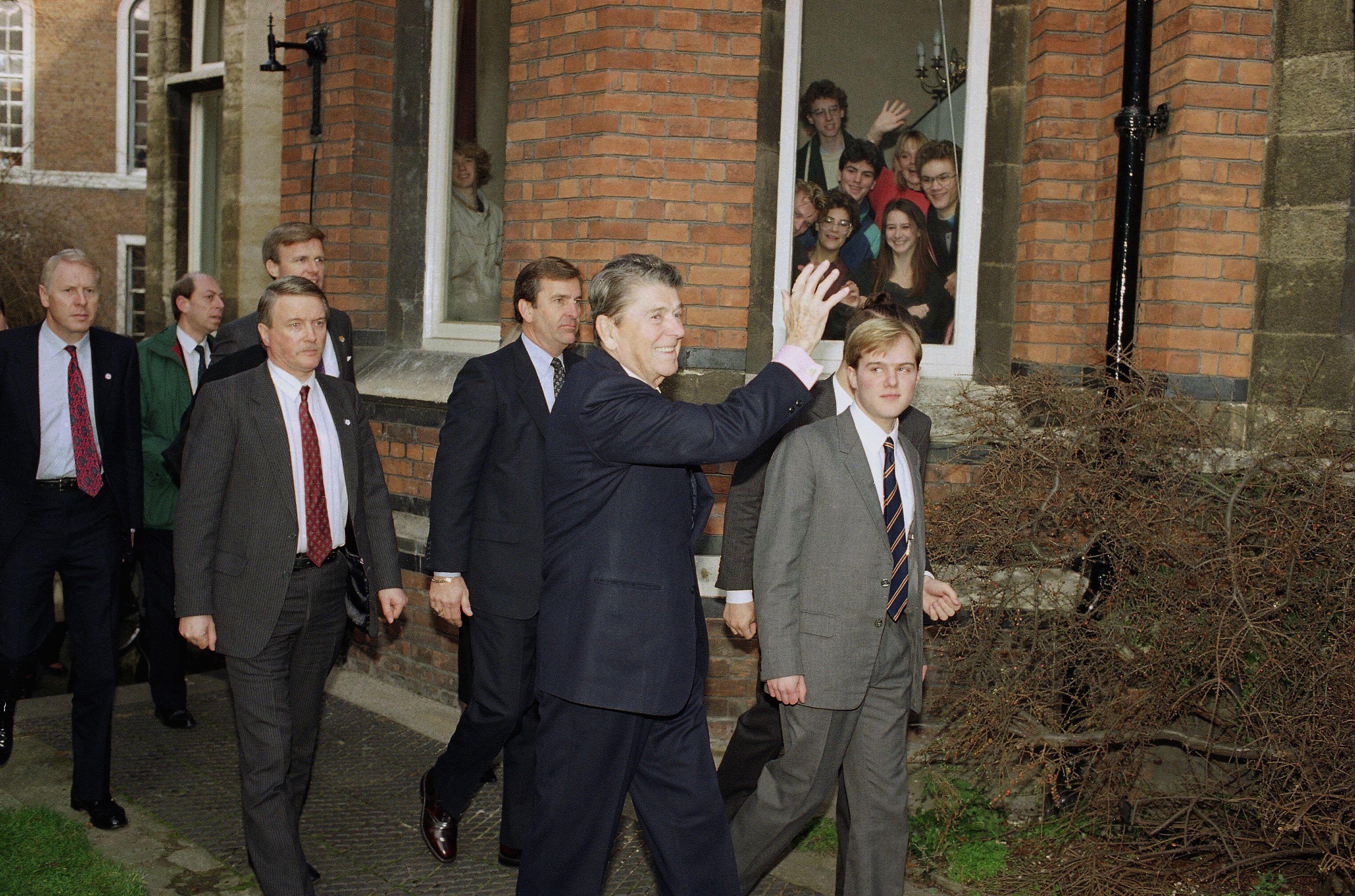 Martin leads US President Ronald Reagan into the Cambridge Union in 1990.