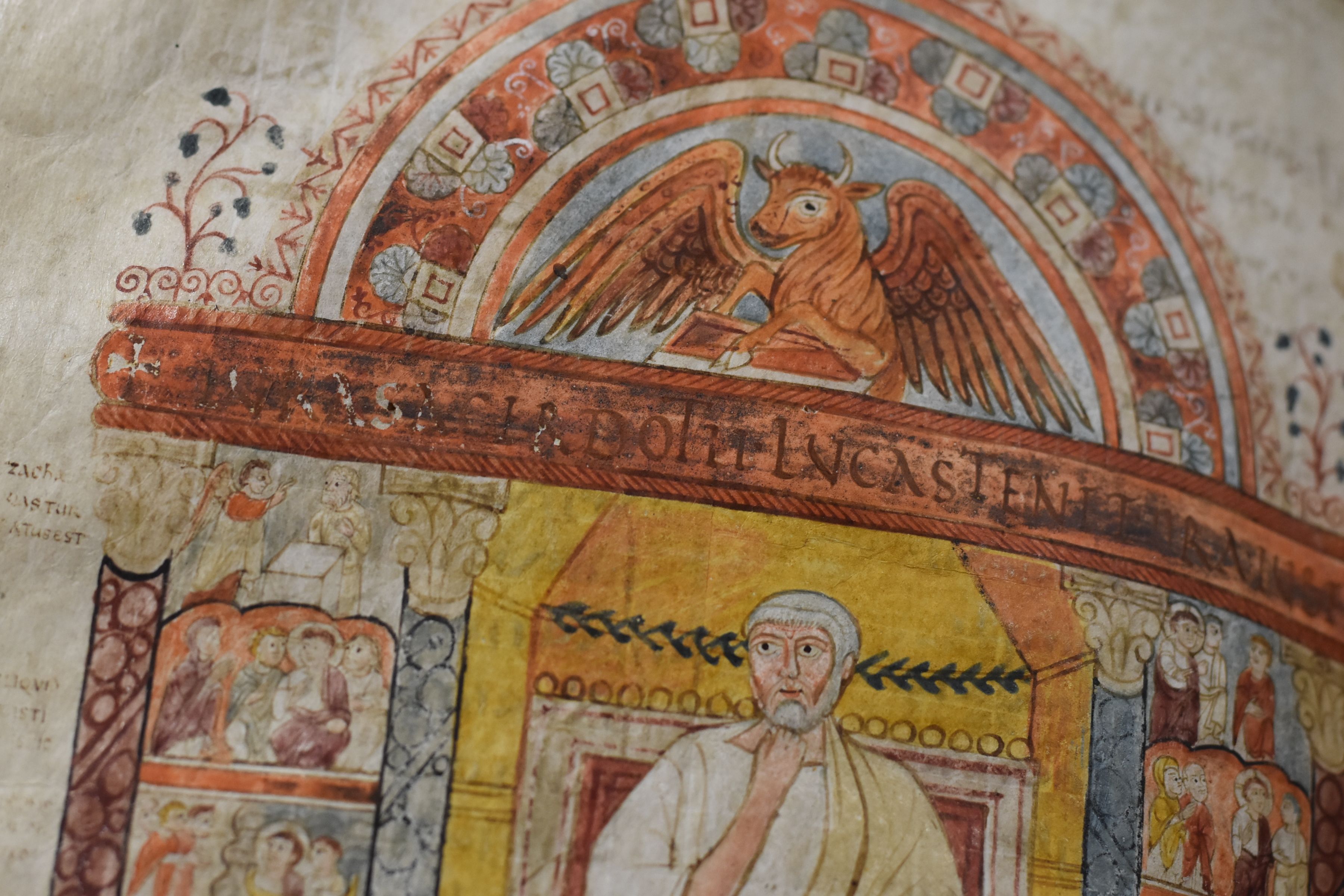 Luke is shown between scenes from the narrative of the Gospel and beneath they symbol of a winged ox.