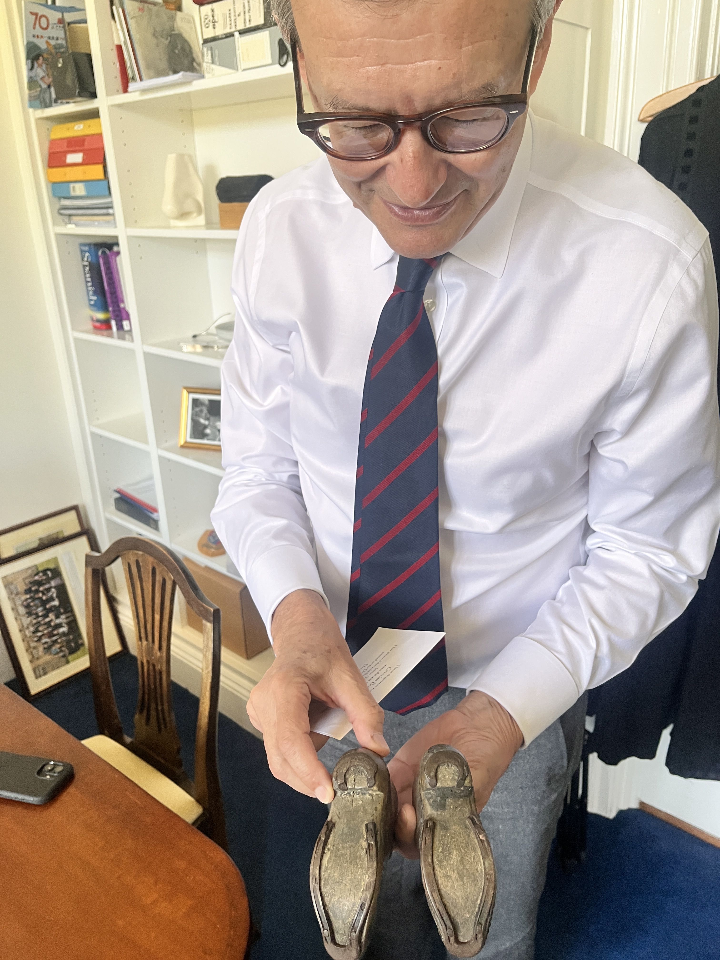 A proud Lancashireman, holding his grandmother's traditional clogs.