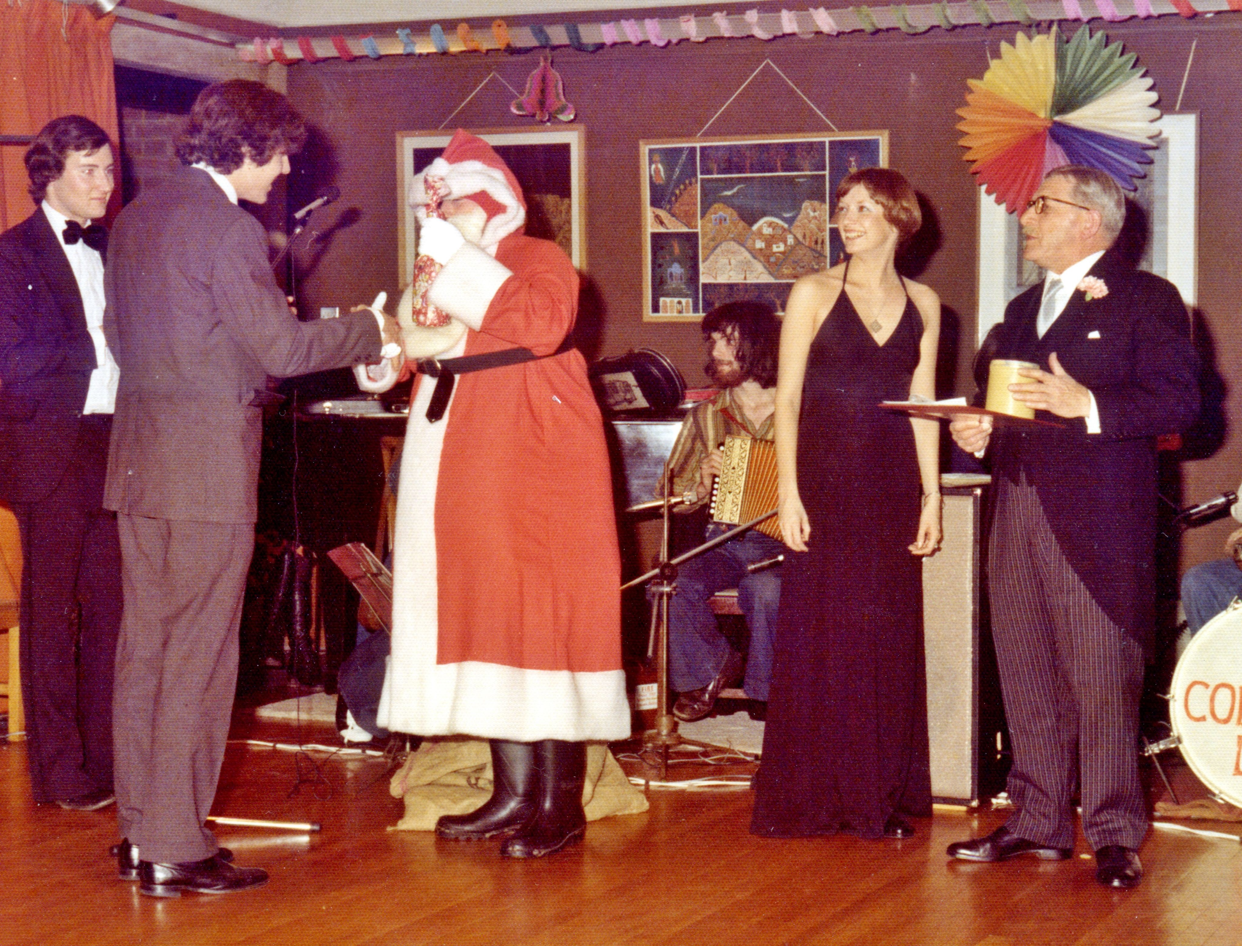 Ian Shaw as Santa at the Leckhampton Christmas Party, with Head Porter Albert Jaggard as Master of Ceremonies. The Bedder would help out behind the scenes.