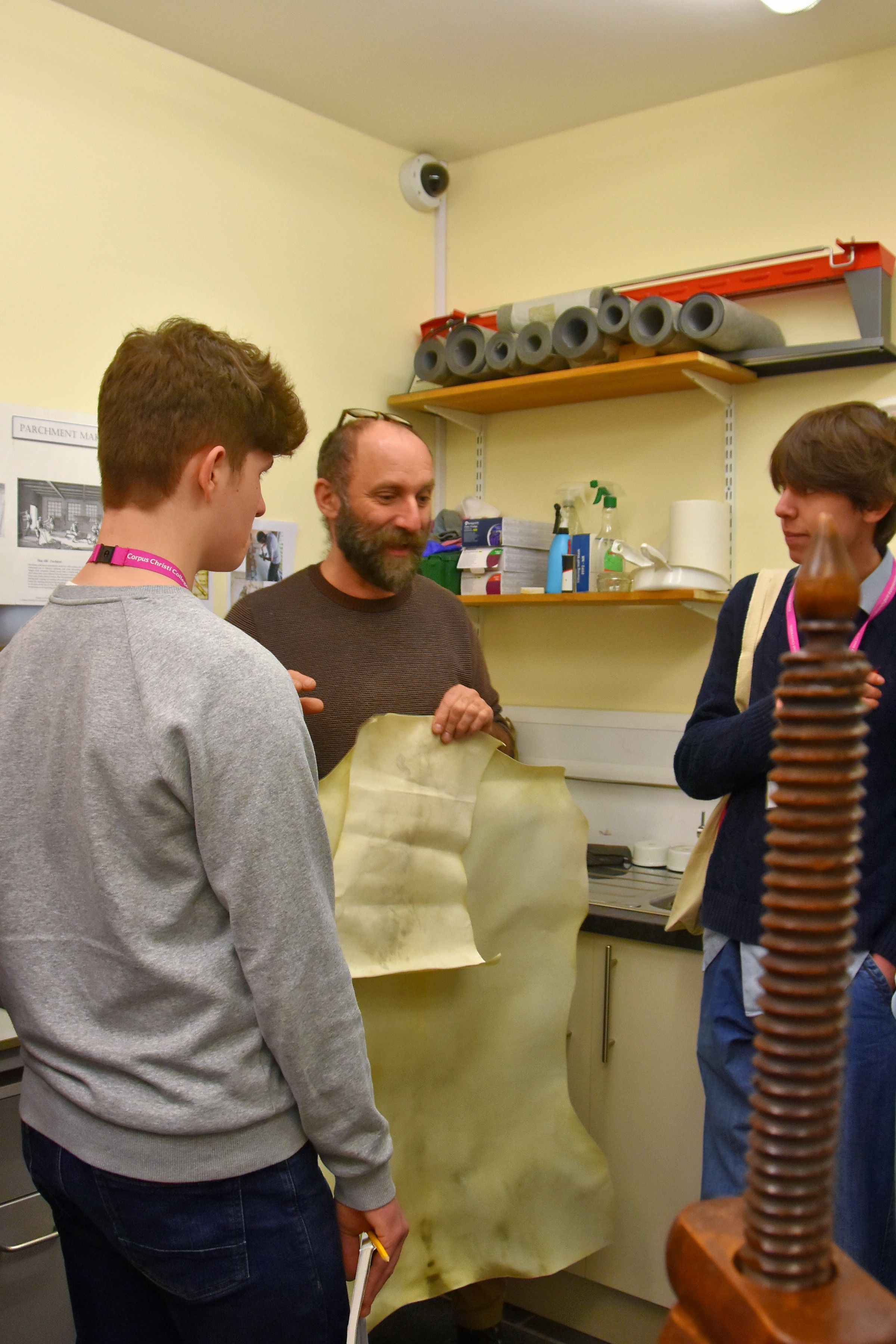 Managing Conservator Flavio Marzo of the Cambridge Colleges Conservation Consortium shows visiting Year 12 students two prepared animal skins: goat and badger. Most medieval manuscript parchment was sheep, goat or - the finest - vellum from veal.